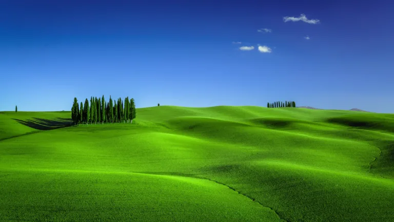 Experience the beauty of the Italian countryside with this 4K wallpaper of green meadows in Tuscany. This stunning landscape features rolling hills, fields, and idyllic scenery that will transport you to the heart of nature and the great outdoors.