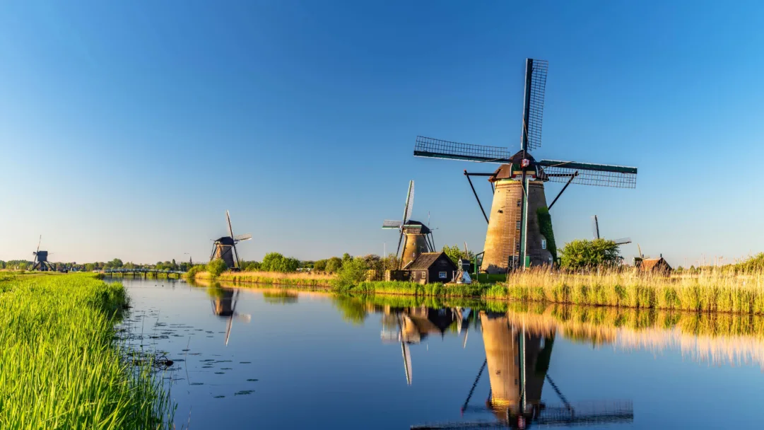 Experience the beauty of the Dutch countryside with this stunning 4K wallpaper of the windmills at Kinderdijk. This picturesque landscape scenery is perfect for nature lovers and those who appreciate the charm of traditional windmills.