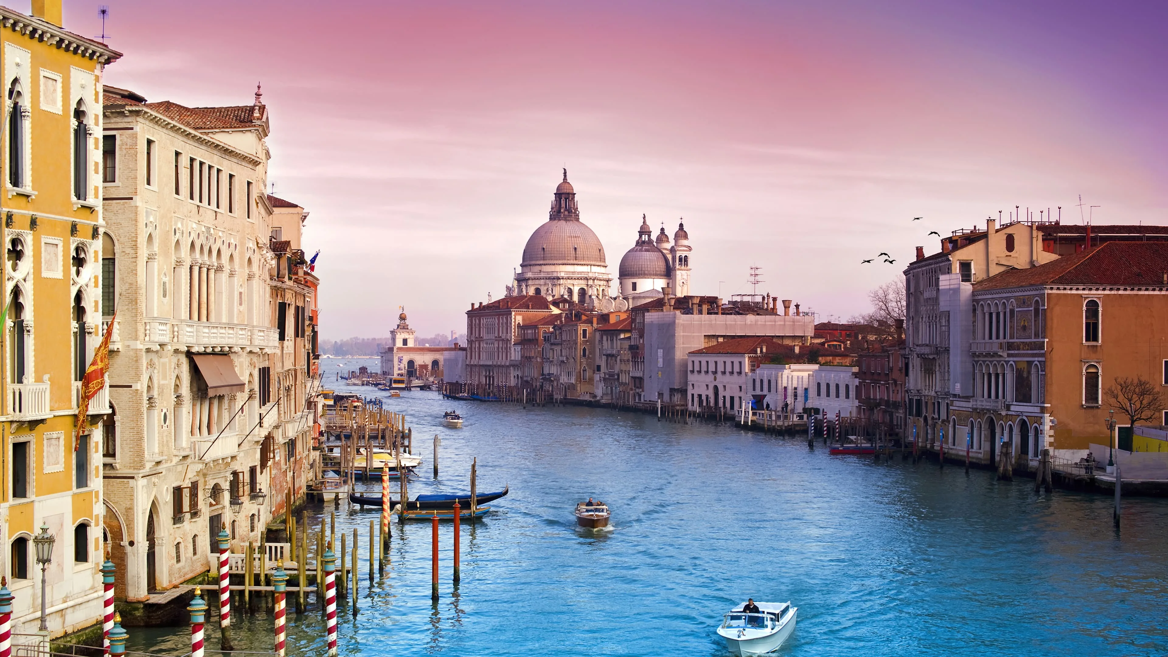 This stunning 4K wallpaper captures the beautiful cityscape of Venice, Italy. The scenery showcases the picturesque buildings and waterways that make this city a popular tourist destination.