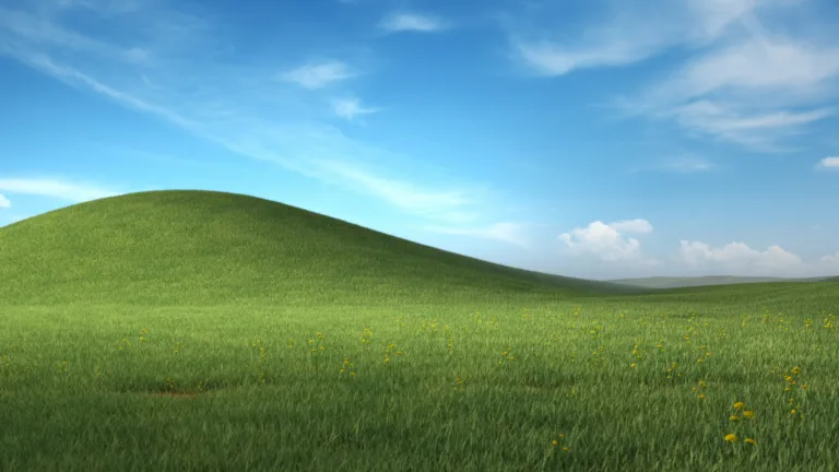 This stunning 4K wallpaper showcases a serene landscape scenery that was famously used as the background image in the classic operating system, Windows XP. Relive the nostalgia of the early 2000s with this beautiful wallpaper that captures the beauty of nature.