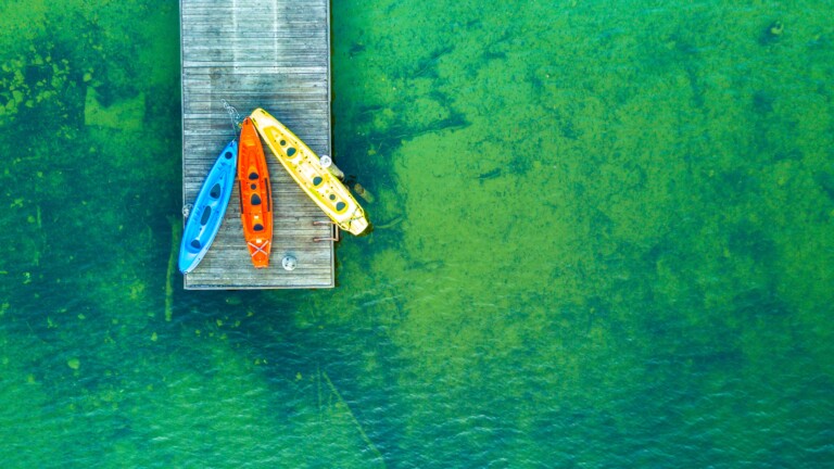 Experience the breathtaking beauty of nature with this 4K wallpaper featuring a peaceful landscape of a wooden pier stretching out into calm waters.