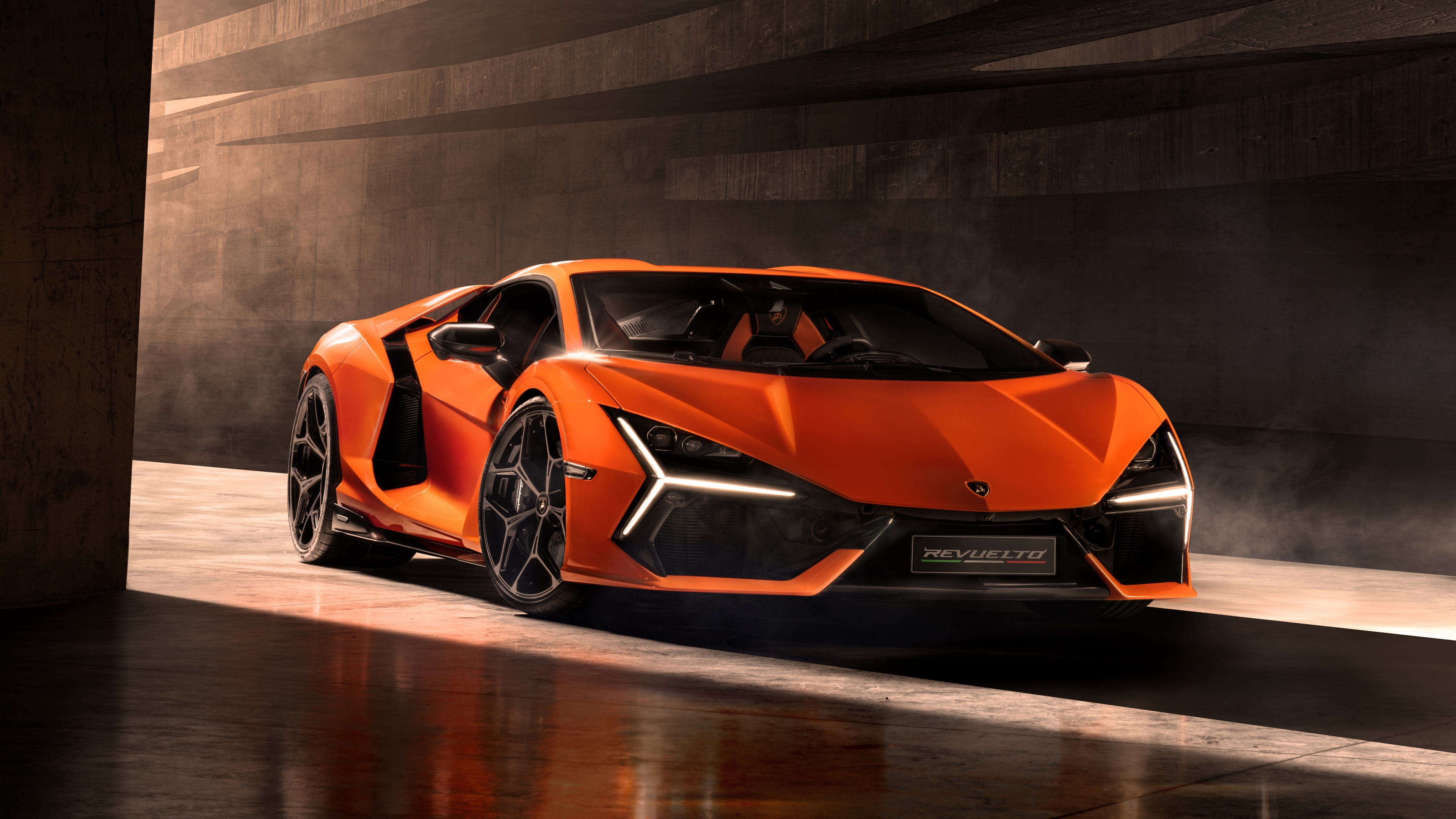 Get up close and personal with the sleek lines and powerful engine of the Lamborghini Revuelto in this stunning 4K wallpaper. Showcasing the luxurious and sporty features of this iconic car, this wallpaper is the perfect choice for automotive enthusiasts and lovers of high-performance vehicles.