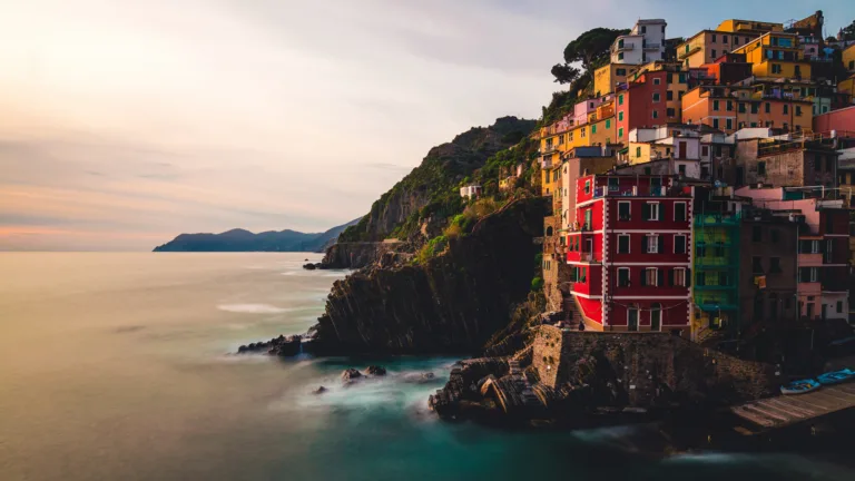 Experience the breathtaking beauty of Riomaggiore, Italy with this stunning 4K wallpaper featuring a picturesque landscape scenery.