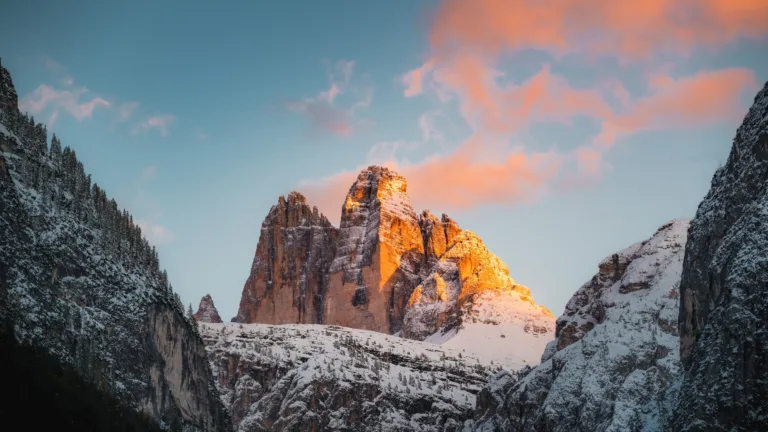 Experience the stunning natural beauty of Italy's Tre Cime di Lavaredo mountain range with this 4K wallpaper. Featuring a breathtaking landscape of rugged peaks and pristine alpine lakes, this outdoor scenery wallpaper is perfect for nature enthusiasts and mountain lovers alike.