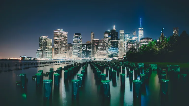A breathtaking view of New York City lights in mesmerizing 4k resolution. This urban wallpaper showcases the vibrant nighttime cityscape with illuminated buildings, capturing the essence of the metropolitan atmosphere.