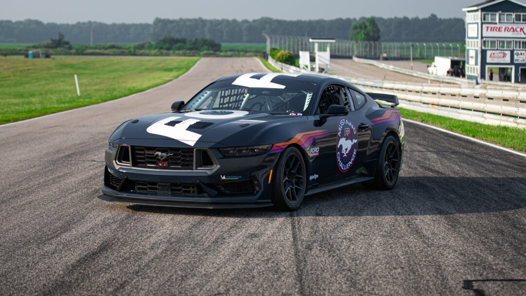 A dynamic 4K wallpaper featuring the Ford Mustang Dark Horse R, a high-performance muscle car, exuding power and elegance in its black beauty.