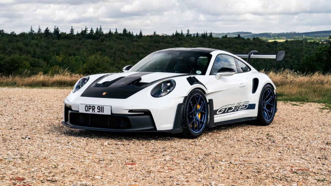 A high-resolution 4K wallpaper featuring the iconic Porsche 911 GT3 RS, a symbol of high-performance and luxury in the automotive world, capturing its dynamic design and speed prowess.