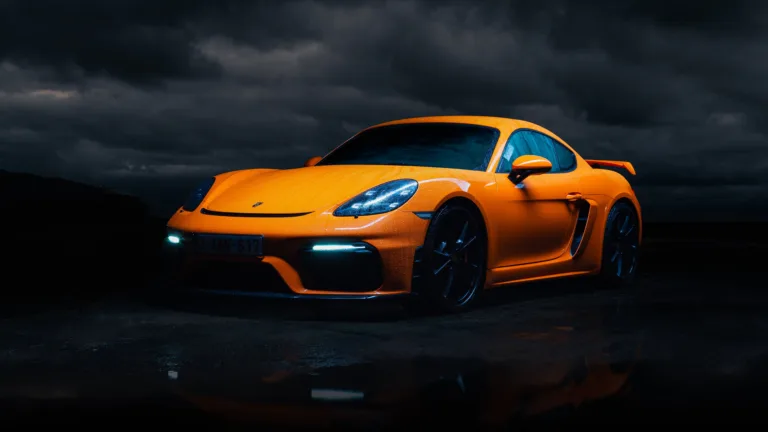 A high-quality 4K wallpaper featuring the Porsche Cayman GT4, a remarkable sports car known for its exceptional performance and sleek design, perfect for car enthusiasts and desktop customization.