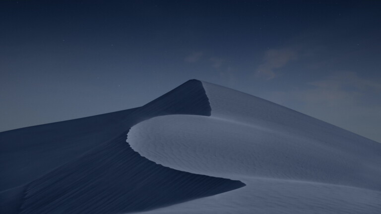 Journey to the heart of the Arabian Desert with this captivating 4K wallpaper capturing the serene beauty of a desert night. Marvel at the majestic sand dunes under a starry sky illuminated by moonlight. Ideal for those who seek the tranquility and mystique of the Arabian Peninsula's desert landscape as a stunning desktop background.