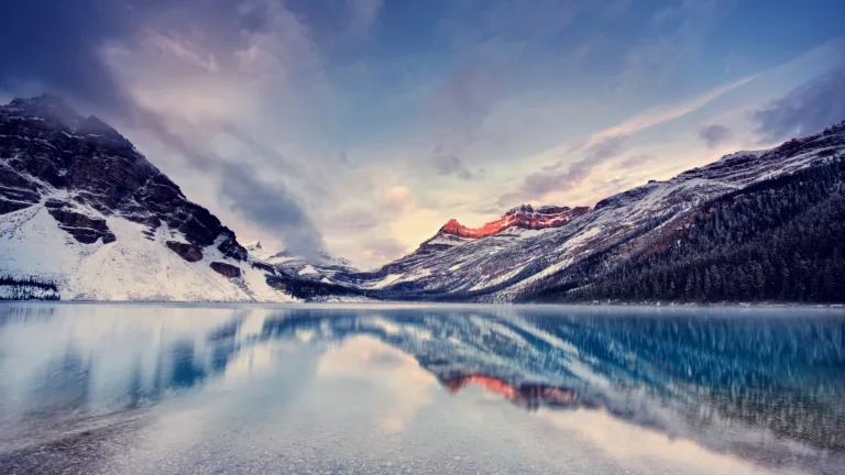 Immerse yourself in the serene beauty of Bow Lake in the Canadian Rockies with this stunning 4K wallpaper. The glacial lake, nestled amidst the rugged Rocky Mountains, offers a tranquil and scenic escape. Perfect for travelers and those seeking a desktop background that captures the natural tranquility and mountainous wonder of this Canadian gem.
