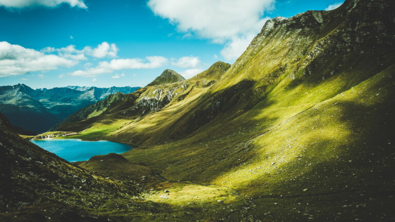 Transport yourself to the serene beauty of Lake Cadagno in the picturesque Piora Valley of Switzerland with this mesmerizing 4K wallpaper. The crystal-clear mountain lake nestled in the Swiss Alps offers a tranquil and scenic escape. Perfect for travelers and those seeking a desktop background that embodies natural tranquility and alpine beauty.