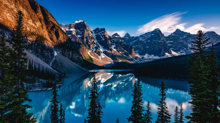 Immerse yourself in the serene beauty of Moraine Lake in Canada with this stunning 4K wallpaper. The turquoise waters, surrounded by the majestic Rocky Mountains in Banff National Park, create a breathtaking scene with perfect mountain reflections. Ideal for travelers and those seeking a desktop background that captures the essence of natural tranquility and scenic wonder.