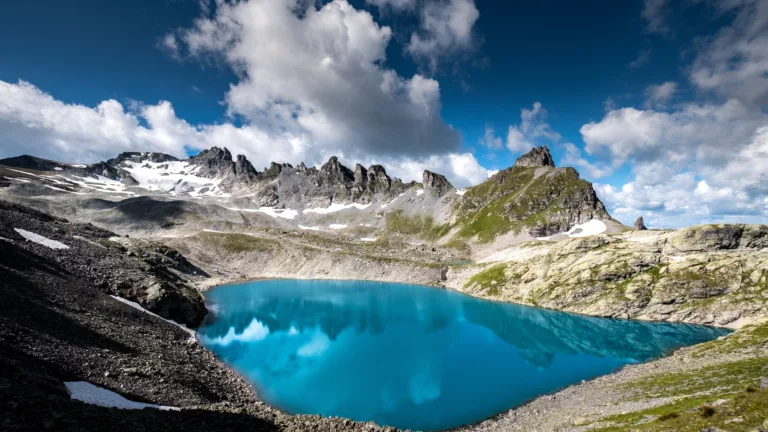 Embark on a visual journey through the stunning Pizol Five Lake Hike in the Swiss Alps with this captivating 4K wallpaper. These pristine mountain lakes, nestled in the alpine landscape of Switzerland, offer a serene and tranquil escape. Perfect for travelers and those seeking a desktop background that embodies natural beauty, serenity, and alpine wonder.
