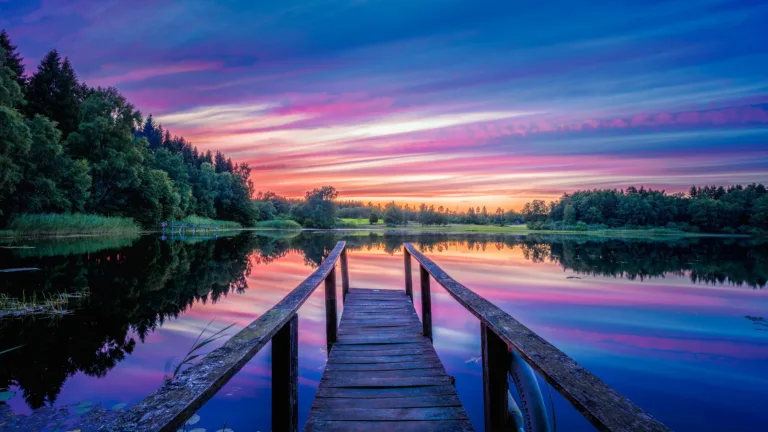 Immerse yourself in the serene beauty of a twilight scene at the dock with this captivating 4K wallpaper. The tranquil waterfront setting bathed in the soft evening light creates a sense of tranquility and peace. Ideal for those who appreciate the beauty of nature and a calming scenic view as a desktop background.