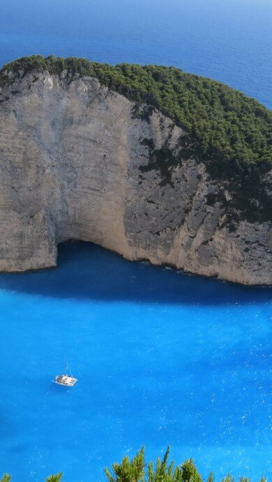 Immerse yourself in the breathtaking beauty of Zakynthos Island in Greece with this captivating 4K wallpaper. The stunning coastline and crystal-clear turquoise waters of the Ionian Sea create a scenic paradise that's perfect for travelers and those seeking a desktop background that captures the natural wonder of this Greek gem.