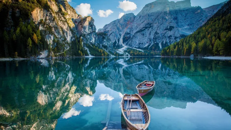 Immerse yourself in the natural beauty of Italy with this breathtaking 4K wallpaper featuring Lago Di Braies. The serene lake nestled in the Dolomites of the Alps is a perfect choice for your high-resolution desktop background.