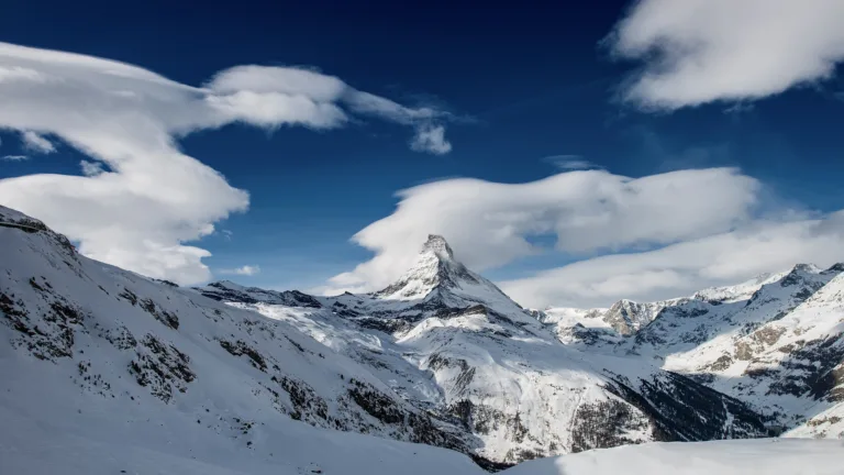 Witness the iconic beauty of Matterhorn Mountain's peak with this magnificent 4K wallpaper. Set against the backdrop of the Swiss Alps, it's an excellent choice for your high-resolution desktop background.