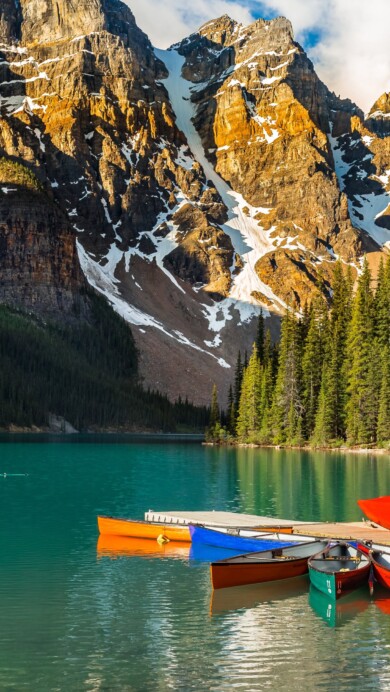 Experience the serene beauty of Moraine Lake in Banff National Park, Canada, with this 4K wallpaper featuring boats on the tranquil turquoise waters. Capturing the picturesque landscape, it showcases the iconic beauty of Moraine Lake in high resolution.