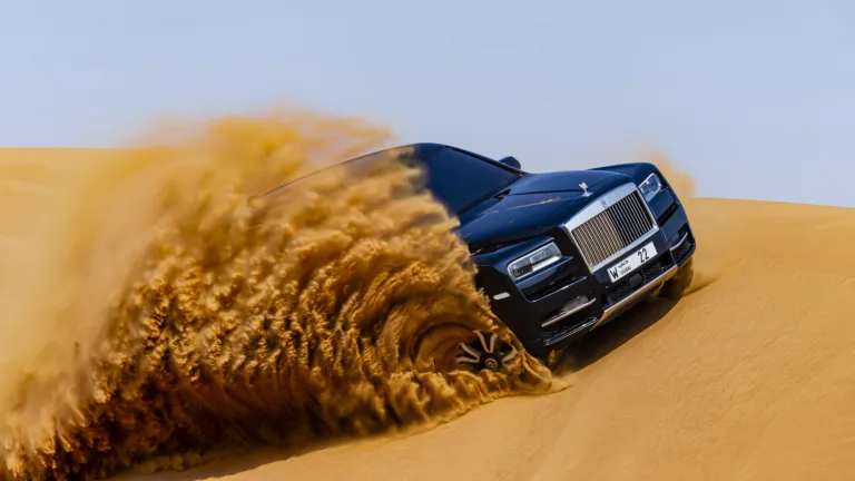 A luxurious 4K wallpaper featuring the Rolls-Royce Cullinan in a breathtaking desert setting. This high-resolution image captures the opulence of the iconic luxury SUV against the expansive desert landscape, creating a visually striking and sophisticated backdrop for desktop or mobile displays.