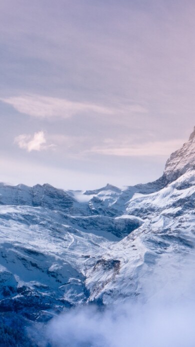 A breathtaking 4K wallpaper featuring the iconic Matterhorn in Switzerland, surrounded by the majestic Alps. The snow-capped peak rises against a stunning alpine landscape, creating a picturesque scene that is perfect for your desktop or mobile wallpaper.