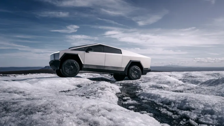 A striking 4K wallpaper capturing the Tesla Cybertruck amidst a pristine snow-covered landscape. The sleek lines of the electric vehicle contrast beautifully with the snowy surroundings, creating a futuristic and captivating scene.