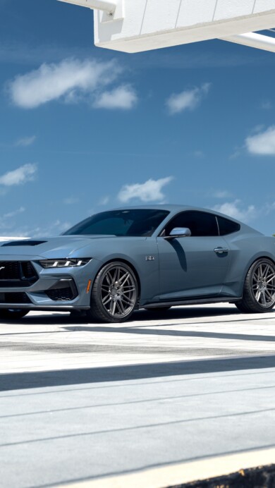 A stunning 4K wallpaper featuring a Ford Mustang GT outdoors, showcasing its sleek and powerful design. The high-resolution image captures the iconic sports car against a scenic backdrop, perfect for enhancing your desktop or mobile screen.