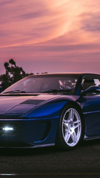 A stunning 4K wallpaper featuring the Ferrari F355 Retro Supercar by Evoluto. The image showcases the car's classic design and sleek lines, capturing the essence of luxury and high-performance driving.