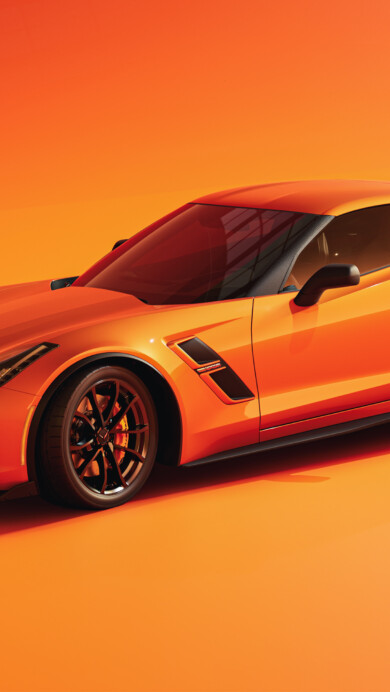 A striking 4K wallpaper featuring an orange Chevrolet Corvette. The sleek design and vibrant color of the car create a bold aesthetic, perfect for car enthusiasts looking for an eye-catching desktop or mobile background.