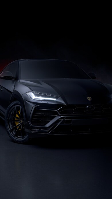A sleek 4K wallpaper featuring the Lamborghini Urus in a dark, moody aesthetic. The high-resolution image highlights the sharp lines and powerful stance of the luxury SUV, set against a shadowy backdrop, perfect for an edgy desktop or mobile wallpaper.