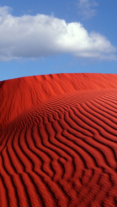 A stunning 4K wallpaper of the iconic Windows XP desert landscape, featuring rolling sand dunes under a clear blue sky. This high-resolution image is perfect for desktop backgrounds, capturing the simplicity and beauty of a desert scene.