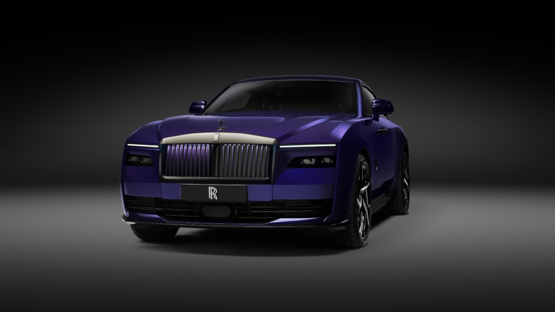 A high-resolution 4K wallpaper featuring the Rolls-Royce Black Badge Spectre 2025, a luxurious all-electric coupe with a sleek black exterior, illuminated grille, and elegant design, set against a dramatic background.