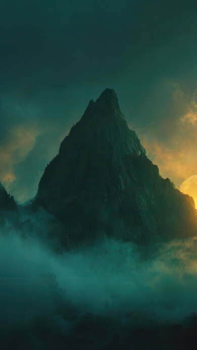 An otherworldly 4K wallpaper capturing a monumental mountain range shrouded in swirling mist, under a dramatic, full moon. The enormous, glowing yellow moon emerges dramatically from behind the central peak, casting a luminous golden-orange light that illuminates the swirling teal-green mist, creating a mystical and ethereal mood.