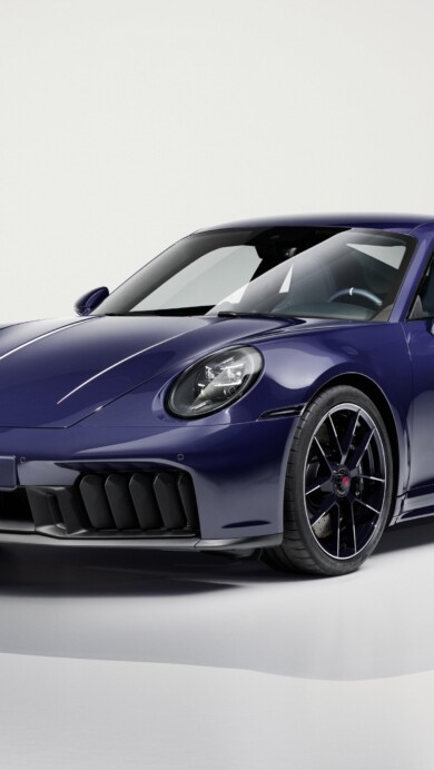 An exhilarating 4K wallpaper featuring a sleek Porsche 911 Carrera GTS 2025, dynamically posed on a high-performance test track. Its gleaming metallic finish and aggressive aerodynamic lines are brilliantly illuminated, conveying a sense of speed and sophisticated power.