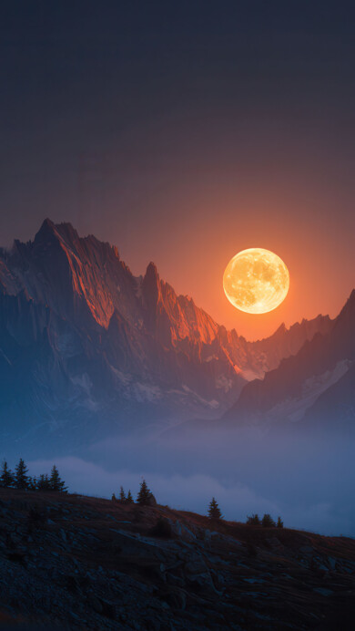 A captivating 4K wallpaper presenting a colossal, glowing orange moon positioned just above a jagged range of dark, majestic mountains at twilight. The moon's intense amber light dramatically backlights the central mountain peaks, making their contours glow warmly against the cool, dark blue and purple hues of the surrounding sky and shadowed landscape, evoking a sense of awe and mystery.