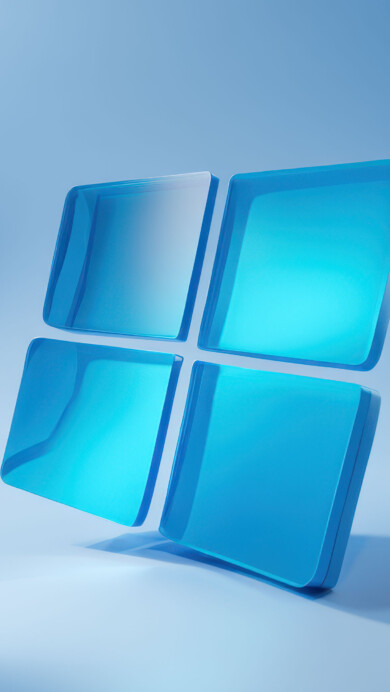 An ethereal 4K wallpaper showcases the Windows 11 logo, rendered as four luminous, translucent blue squares, gracefully floating above a subtly undulating, abstract blue surface. Soft light illuminates the logo, particularly brightening its top-left pane, while gentle shadows and fluid background shapes create a serene and modern aesthetic.