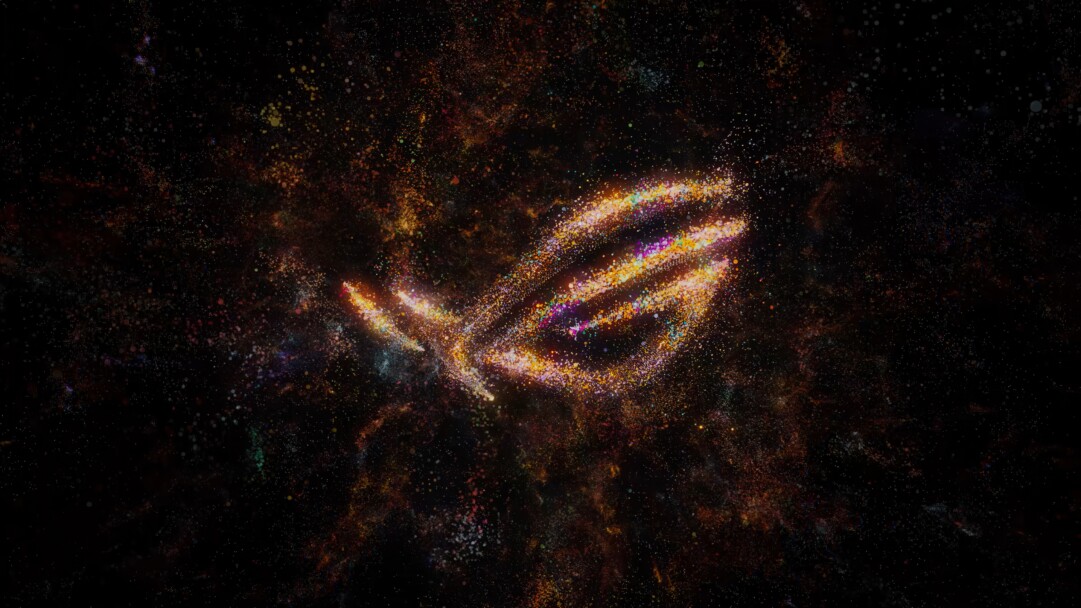 A captivating 4K wallpaper displaying the Asus ROG logo, vividly rendered from a swirling vortex of vibrant, multi-colored cosmic particles against a deep black, star-strewn background. The logo glows with an intense, fiery energy, its form intricately detailed by countless tiny, luminous specks of orange, yellow, pink, and blue, suggesting motion and a powerful, ethereal presence within the vast darkness.