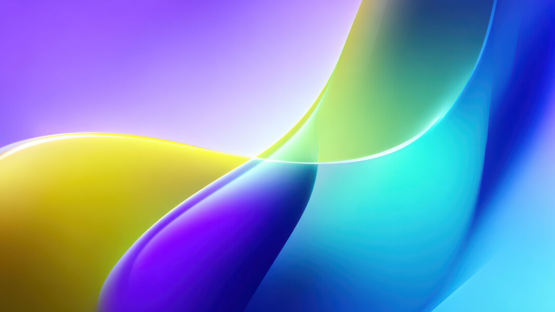 A stunning 4K wallpaper features flowing, iridescent colorful fluid waves, emblematic of the modern Windows 11 interface. Luminous bands of light accent the graceful curves, highlighting their glossy textures and contributing to an overall sense of vibrant, fluid motion.