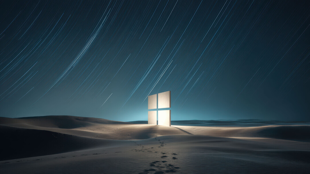 An ethereal 4K wallpaper showcases a towering, glowing four-pane window structure standing centrally in a vast, dark desert under a star-streaked night sky. Its brilliant cool light illuminates the intricate patterns of the surrounding sand dunes, while long, luminous star trails streak across the deep blue expanse above, creating a mysterious, futuristic vista.