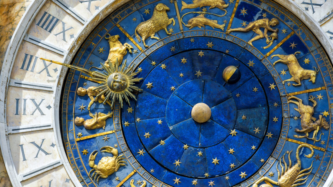 A captivating 4K wallpaper presents a detailed close-up of the astronomical dial on St. Mark's Clock Tower in Venice, Italy. Golden zodiac figures and constellations stand out against the deep lapis lazuli blue of the central dial, beautifully illuminated to showcase its intricate historical craftsmanship.