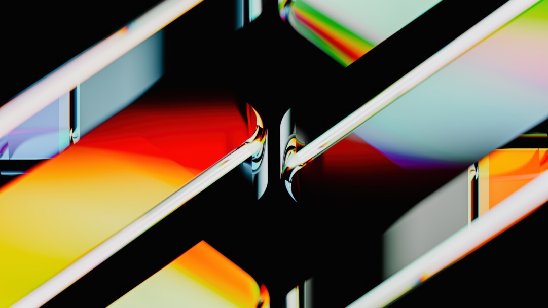 A dazzling 4K wallpaper presenting an abstract composition of luminous glass-like forms against a deep black background. Its mesmerizing design highlights the complex interplay of light, creating vivid refractions of red, orange, green, and blue hues that flow and bend dramatically across the scene, defining a dynamic and visually rich mood.