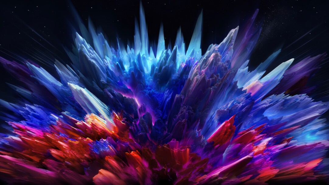 A captivating 4K wallpaper erupts with a vibrant cosmic color burst, manifesting as sharp, crystalline forms against a dark, starry void. The explosion transitions from intense blue and purple spikes at the top to fiery reds and oranges at the base, creating a sense of powerful, dynamic energy.