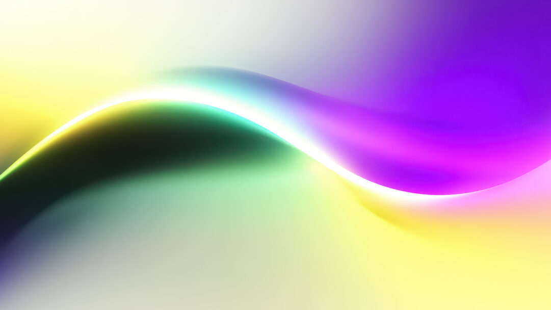 A mesmerizing 4K wallpaper presents an abstract gradient wave flowing gracefully across the frame, ideal as a vibrant Windows 11 desktop background. Its luminous white crest elegantly defines the curve, separating a warm blend of yellow and green from a rich, calming spectrum of teal and purple hues.