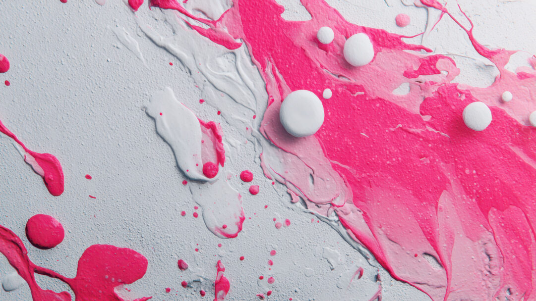 A captivating 4K wallpaper showcases a dynamic abstract composition featuring vibrant pink and textured white paint, emphasizing its fluid and expressive forms. Thick streams and delicate splatters of fuchsia intertwine with the coarse white background, adorned with smooth, contrasting white spheres that add three-dimensional depth and accentuate the energetic flow.
