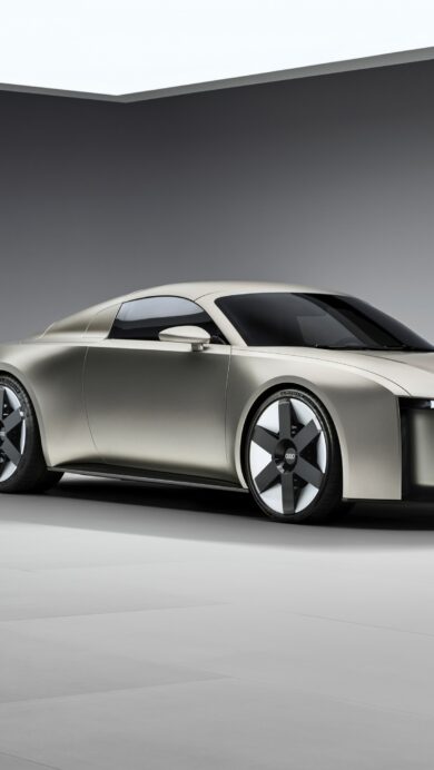 A dynamic 4K wallpaper presenting the Mercedes-AMG GT2 Edition race car speeding along the iconic Monza Race Track. Its sleek gray body with vibrant teal racing stripes and accents is blurred against the track, emphasizing exhilarating speed under a bright sky.