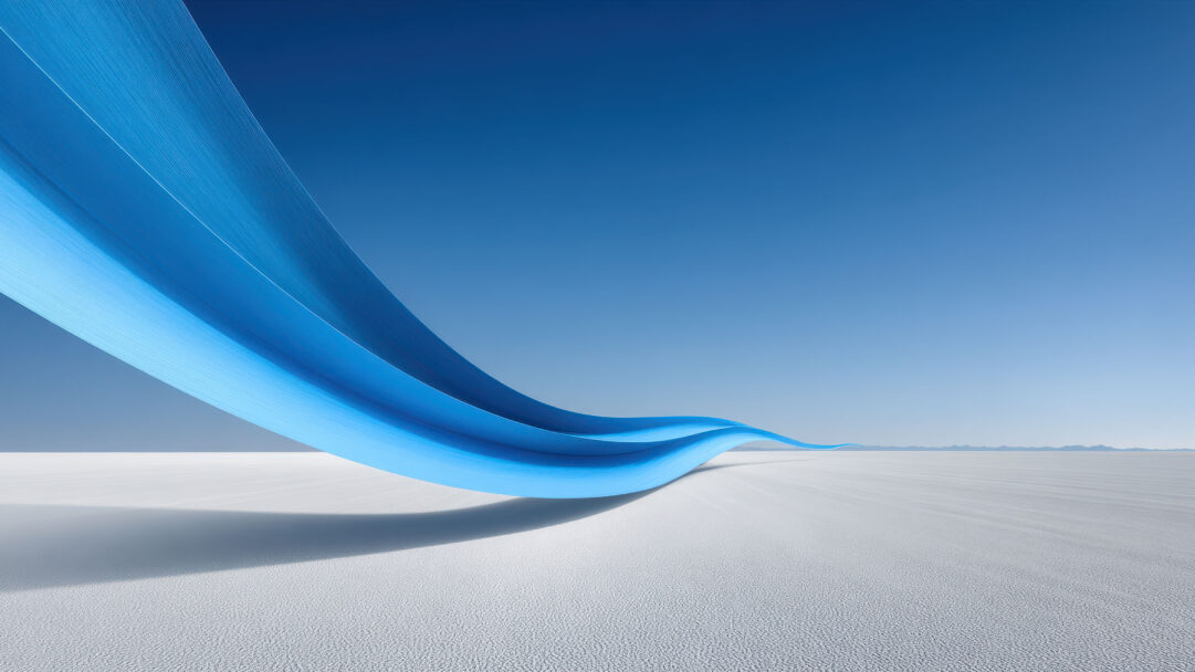A sweeping 4K wallpaper showcases a dynamic blue ribbon curve of digital art floating gracefully over a vast, textured white landscape under a clear blue sky. The ribbon displays vibrant gradients of light and dark blue, casting a long, soft shadow that adds depth and movement to the minimalist, serene scene.
