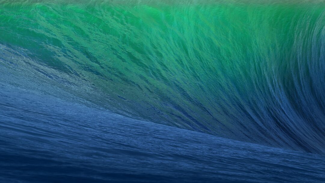 A breathtaking 4K wallpaper captures the iconic OS X Mavericks ocean wave, dynamically cresting in a vast blue expanse. The water transitions from a deep, rich blue at the base to a luminous emerald green at the sunlit peak, highlighting its immense power and fluid texture.