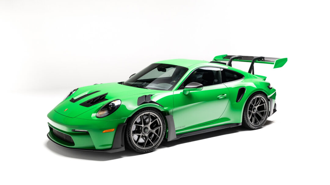 An exhilarating 4K wallpaper featuring the 2025 Porsche 911 GT3 RS Rexy, meticulously displayed in a pristine studio setting. Its striking vibrant green paint, aggressive aerodynamic elements, and prominent rear wing emphasize its powerful, race-ready character.