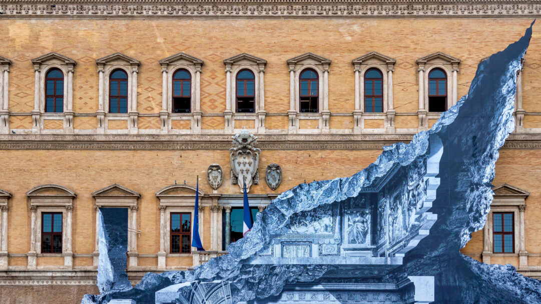 A thought-provoking 4K wallpaper depicting the iconic Palazzo Farnese facade transformed by a dramatic installation art piece. This 'Jr Vanishing Point' installation features a massive, jagged tear in the building, revealing a grayscale, cavernous interior with classic architectural details, creating a surreal optical illusion of depth.