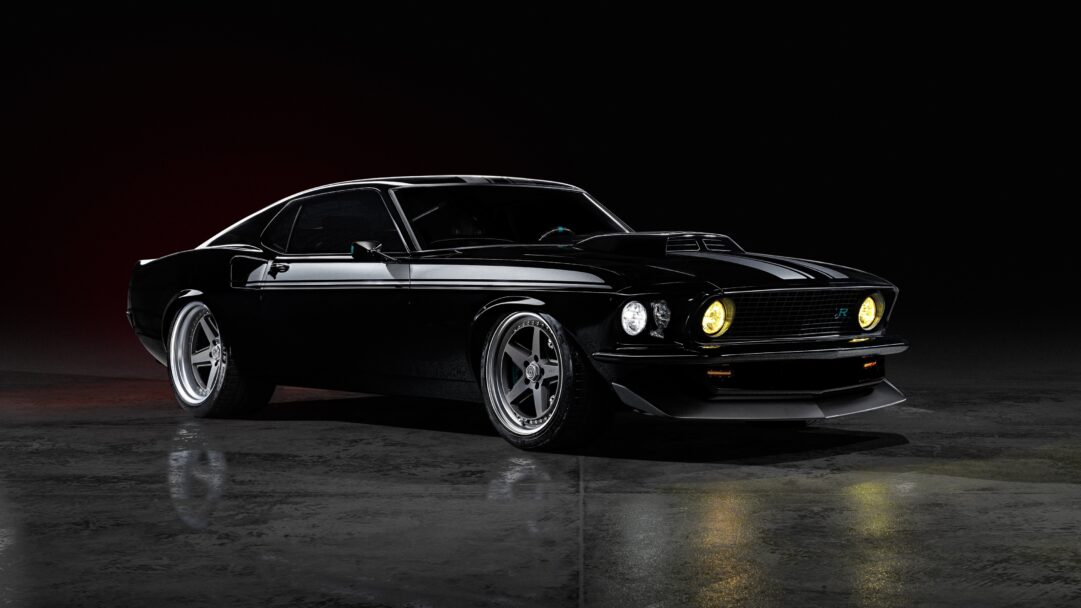 An iconic 4K wallpaper showcasing a black classic Ford Mustang muscle car, parked on a gleaming wet dark floor against a subtly lit dark background. Its sleek, glossy body reflects the ambient light, while the glowing yellow headlights pierce through the darkness, emphasizing its potent and mysterious presence.