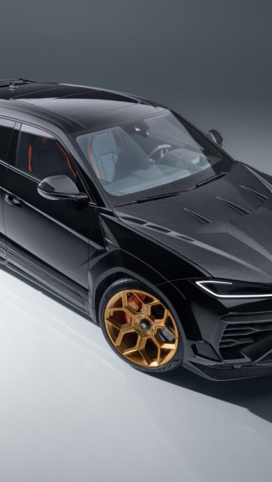 A powerful 4K wallpaper showcasing a sleek black Lamborghini Urus luxury SUV, perfectly poised in a minimalist studio setting. Its striking gold wheels dramatically contrast with the glossy black body, while professional lighting emphasizes the vehicle's sharp lines and luxurious presence.